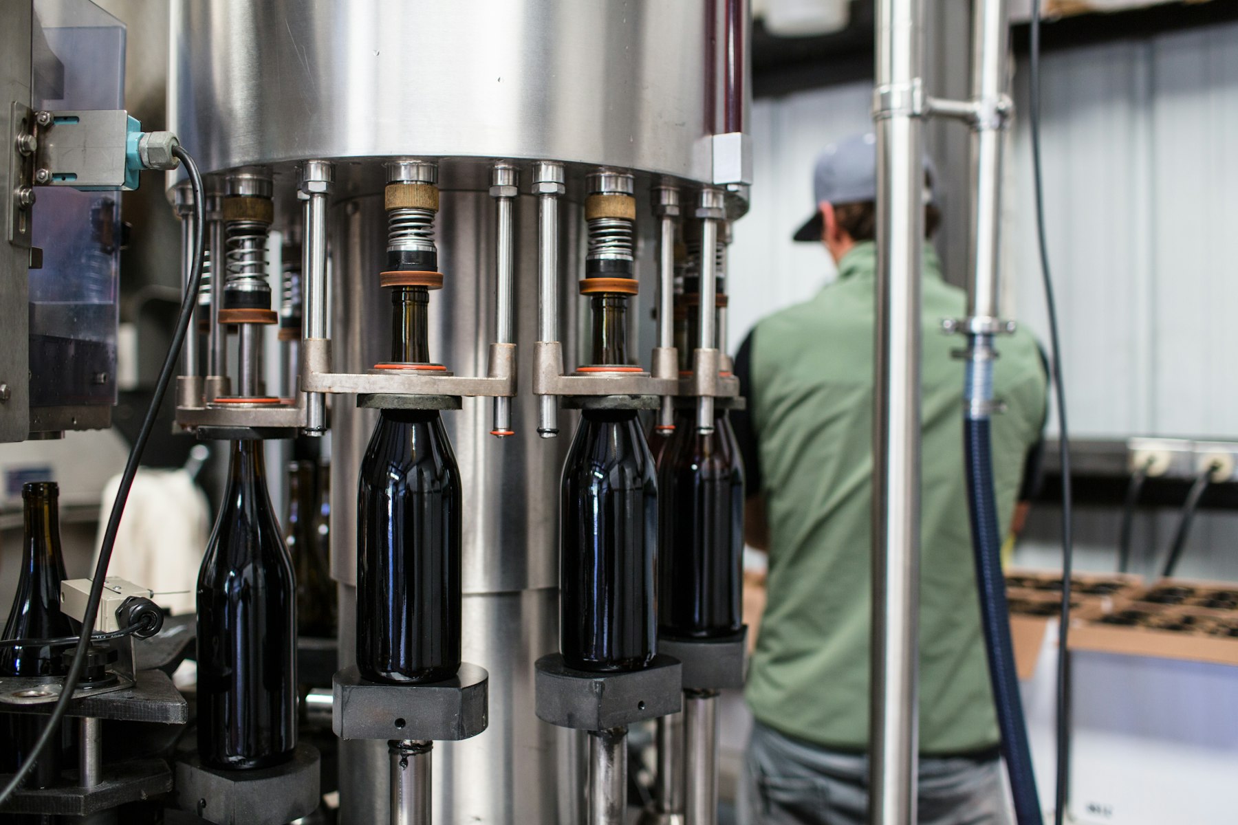 Wine bottles being sealed by an automated capping machine